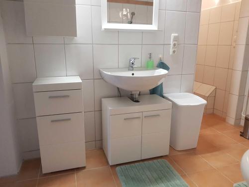 a bathroom with a sink and a toilet at Fewo Storchennest in Kollmar