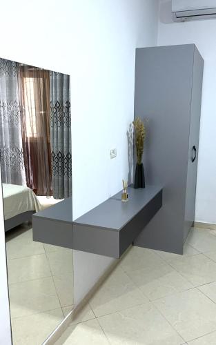 a gray table in a room with a bed at Berat Central Apartment in Berat