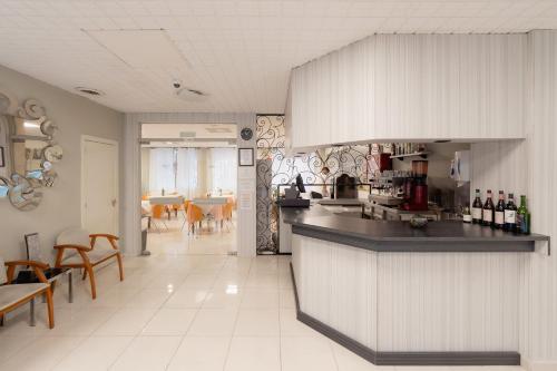 a kitchen with a counter and a dining room at Hotel Santa Faz in Benidorm