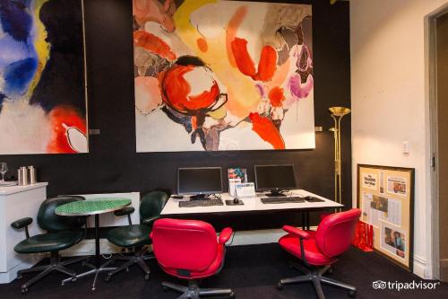 an office with red chairs and a desk with a computer at Tolarno Hotel - Balazac Room - Australia in Melbourne