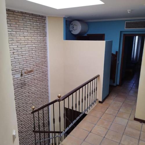a hallway with a staircase and a brick wall at Apartamentos Jasmund - Bungalow 87 in San Fernando
