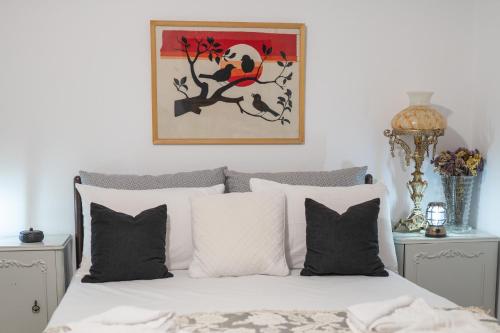 a bedroom with a bed and a painting on the wall at MARKOS' HOUSE in Agiassos