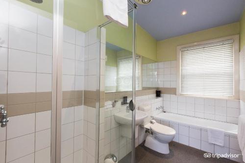 a bathroom with a shower and a toilet and a sink at Tolarno Hotel - Balazac Room - Australia in Melbourne