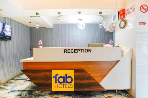 a reception desk with a sign in a room at FabExpress Royal Bird in Ahmedabad