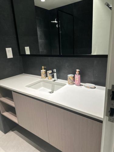 a bathroom counter with a sink and a mirror at WelcomeHome Apartments Aljada in Sharjah