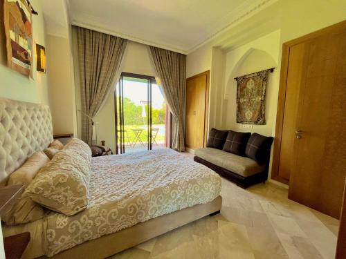 a bedroom with a bed and a couch and a window at Entire villa with private pool in Marrakech in Marrakesh