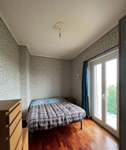 a bedroom with a bed and a large window at Casa indipendente con panorama stupendo in Montegiorgio