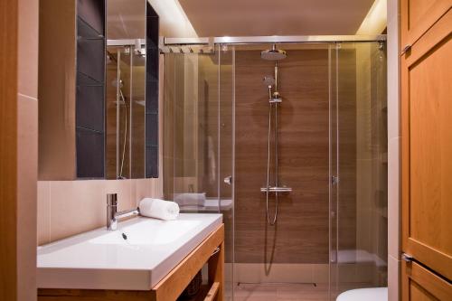 a bathroom with a sink and a shower at PRESTIGE PARK Apartament z garażem in Krynica Zdrój
