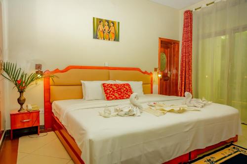 En eller flere senge i et værelse på Home Inn Hotel Rwanda