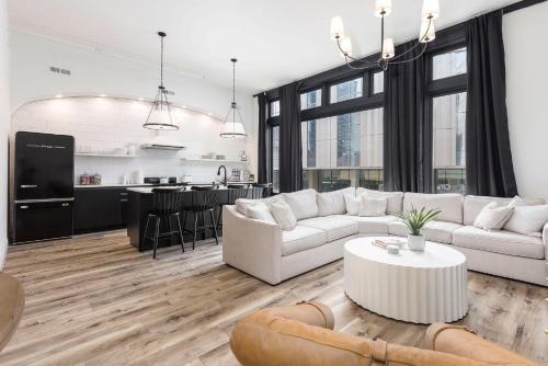 a living room with a white couch and a table at Decadent Cityscape Retreat in Louisville