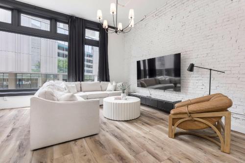 a living room with a couch and a fireplace at Decadent Cityscape Retreat in Louisville