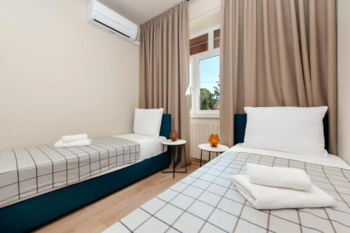 a bedroom with two beds and a window at Holiday Home Istarska in Rovinj