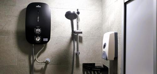 a bathroom with a hair dryer on the wall at Guesthouse@ Bukit Bintang in Kuala Lumpur