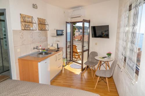 a small kitchen with a sink and a table at Apartments Caric in Hvar