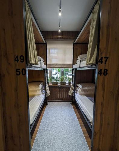 two bunk beds in a room with a window at Aiva Hostel in Bishkek