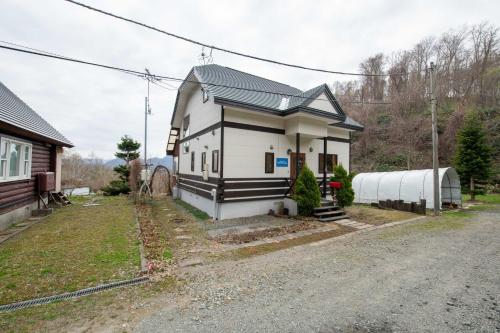 a small house on the side of a road at Lake Toya Terrace House in Tōya