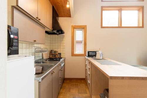 a kitchen with a sink and a counter top at Lake Toya Terrace House in Tōya