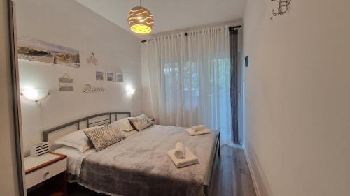 a bedroom with a bed with two towels on it at Apartments Godena in Rovinj