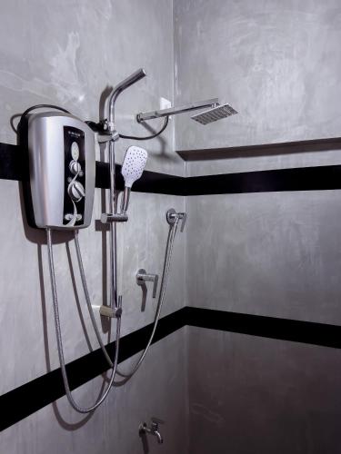 a shower in a bathroom with a hair dryer at Light House View Inn - Galle Fort in Galle
