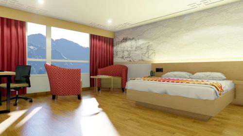 a hotel room with a bed and a table and chairs at Ginger Gangtok in Gangtok