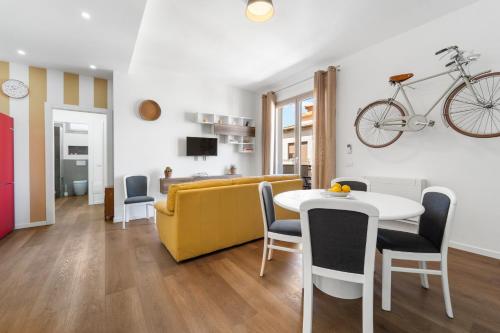 a living room with a yellow couch and a table at 4 Seasons Apartment in Guspini
