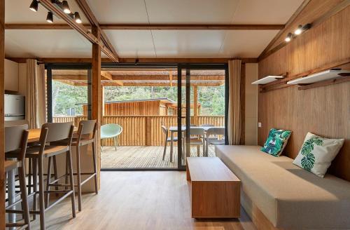 a room with a couch and a kitchen and a table at Camping Cala Pola in Tossa de Mar