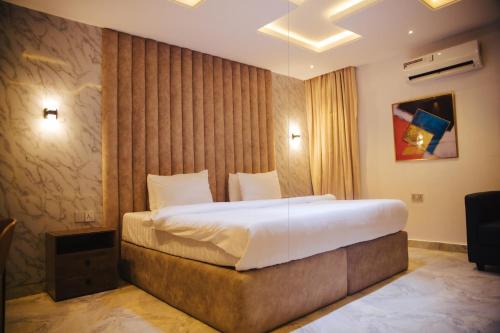 a bedroom with a large bed in a room at DE LEVERAGE HOTEL & SUITES in Lagos