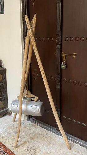 a pair of wooden sticks next to a door at Al Koot Heritage Hotel in Al Hofuf