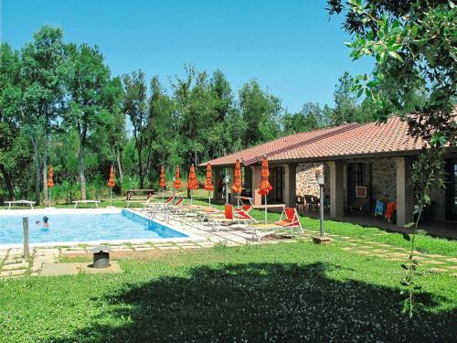 a large swimming pool with chairs and a house at il Carpignone in La Pesta