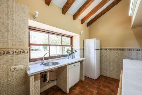 a kitchen with a sink and a refrigerator at Stunning 13th Century Luxury Villa* Garden & Pool in Avila