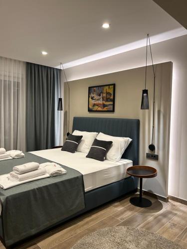 a bedroom with a large bed and a table at Luxury Villa Mikolina in Kornić