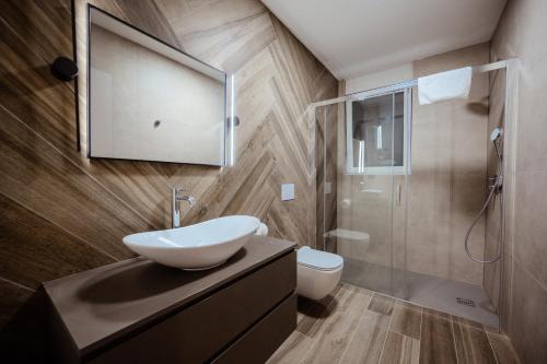 a bathroom with a sink and a toilet and a mirror at Luxury Villa Mikolina in Kornić