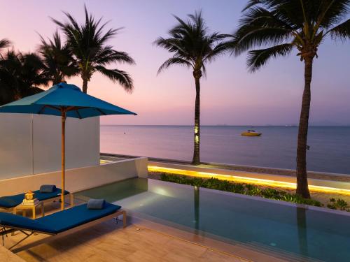 a villa with a infinity pool and palm trees at Explorar Koh Samui - Adults Only Resort and Spa in Mae Nam