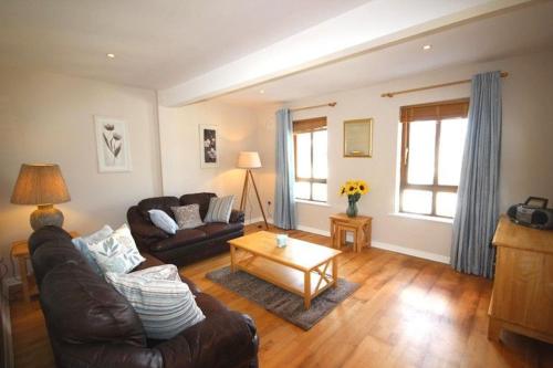 a living room with a couch and a coffee table at 2 Clifden Court in Clifden