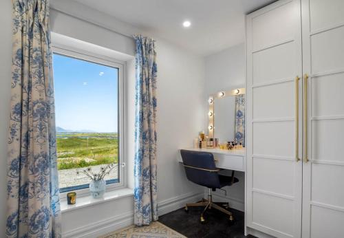 a bathroom with a window and a desk and a window with a view at Sweet Garden, Mannin - Ballyconneely in Ballyconneely