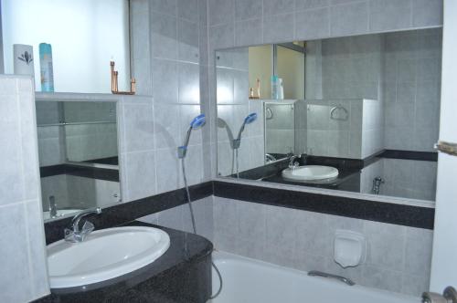 a bathroom with two sinks and a shower at Sea view short stay home in Durban