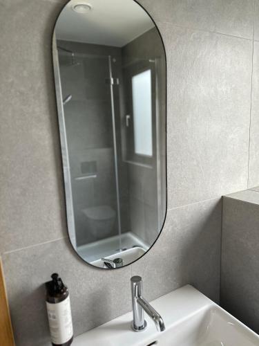 a mirror above a sink in a bathroom at Domki Piwniczna in Piwniczna