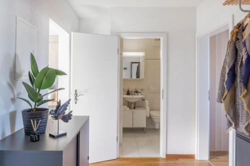 a white bathroom with a toilet and a sink at Special PICCO PICASSO Apartment Basel, Bahnhof Grossbasel 10-STAR in Basel