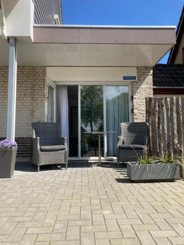 a patio with chairs and a table on a house at Studio Lodo in Middelburg