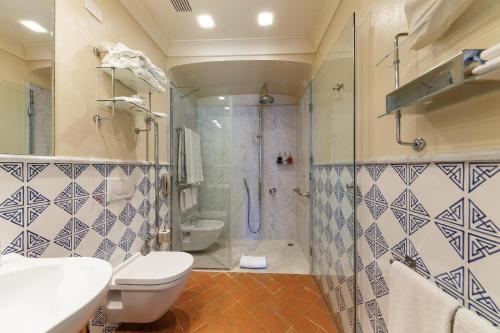 a bathroom with a shower and a toilet and a sink at Borgo Scopeto Wine & Country Relais in Vagliagli