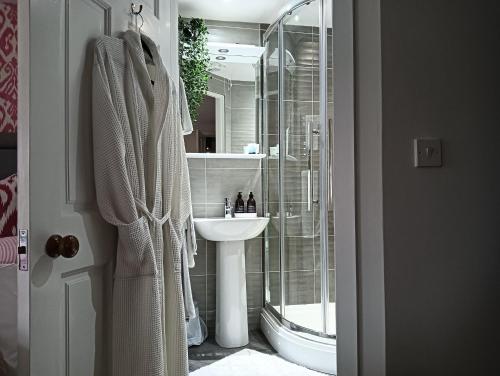 a bathroom with a glass shower and a sink at Lucker mill house in Lucker