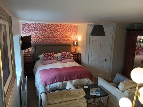 a bedroom with a bed and a couch at Lucker mill house in Lucker