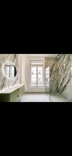 a bathroom with a sink and a mirror and a window at Annavila in Piešťany