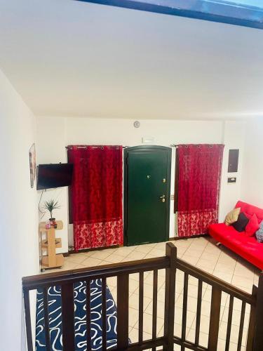 a balcony with red curtains and a green door at Private house in the center of Mestre (Venice) in Mestre