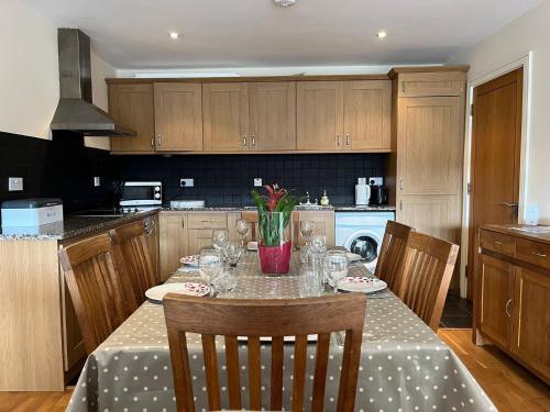 a kitchen with a table with wine glasses on it at 5 Courthouse Square Clifden in Clifden