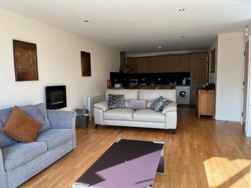 a living room with a couch and a table at 5 Courthouse Square Clifden in Clifden