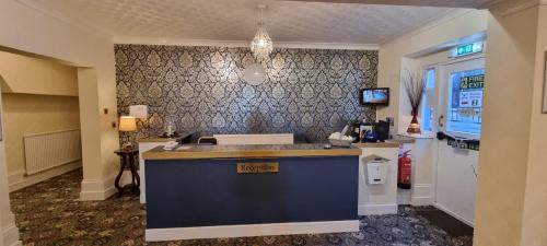 a kitchen with a sink and a counter top at Royal Pier in Sandown