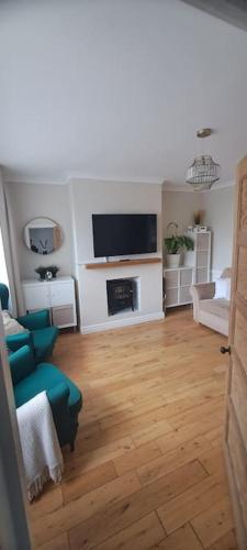 a living room with a couch and a television at 3 Bed Home in Heart of Cardiff in Cardiff