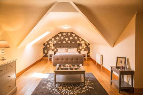 a attic bedroom with a bed and a table at Once Upon a Tide in Clifden
