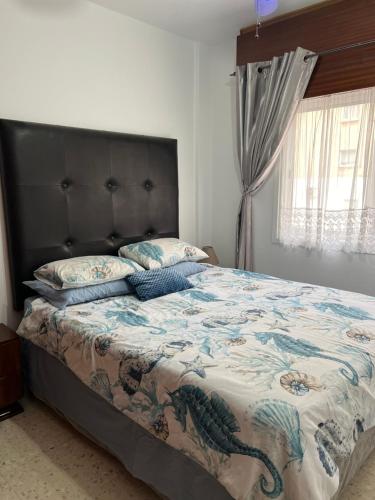 a bedroom with a large bed with a dragon comforter at Maresea rooms in Larnaca